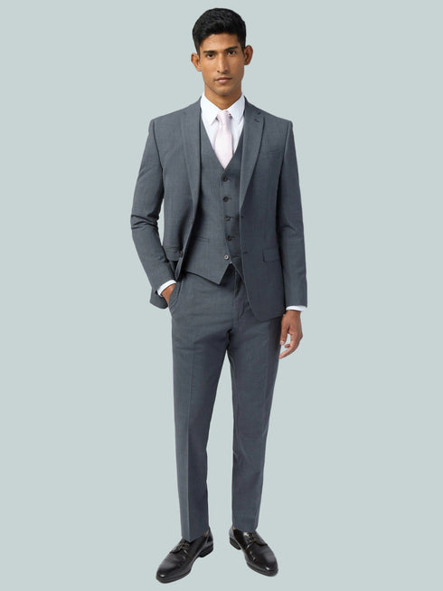 Man wearing a gray suit with a white shirt on a white background