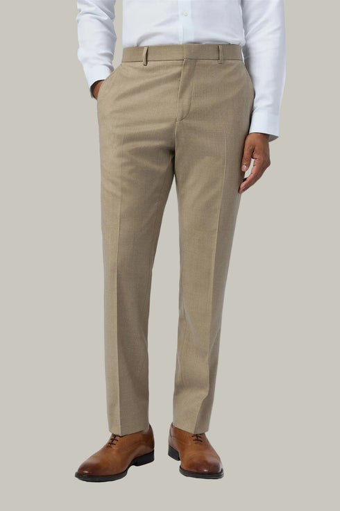 Beige pants worn by a person on a white background