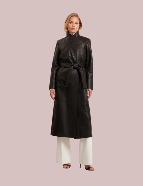 Woman wearing a black leather coat on a light gray background